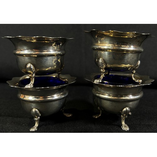 225 - Four early 20th century silver salt cauldrons with blue glass liners in a box and a single christeni... 