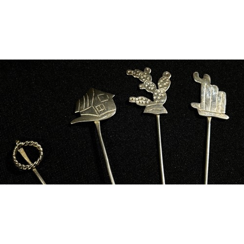 226 - Twelve Mexican silver cocktail sticks/forks stamped 925 decorated with cacti, sombrero, an earthenwa... 