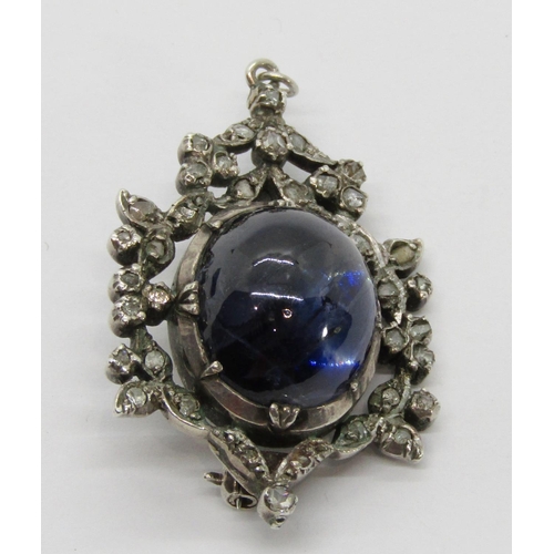 389 - 19th century silver brooch / pendant collet set with a large cabochon sapphire within rose-cut diamo... 