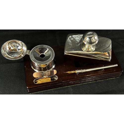 233 - A silver pen and inkstand with a silver inkwell and blotter and a small hinged space for a selection... 