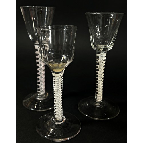 145 - Three 18th century English opaque cotton twist stem wine glasses, 14cm, 15.5cm and 16.3cm