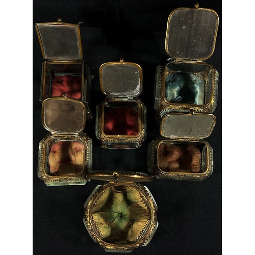 163 - Six late 19th century glass gilt metal mounted jewellery caskets, with Parisian landmarks to the lid... 