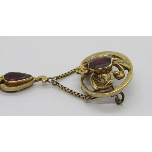 282 - 19th century yellow metal garnet drop brooch with scrolled detail, 6cm L approx, 7.4g