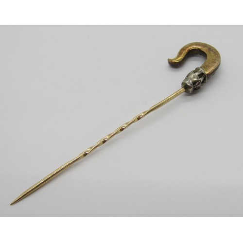 285 - 19th century yellow metal stick pin in the form of a shepherd's crook, set with graduated rose-cut d... 