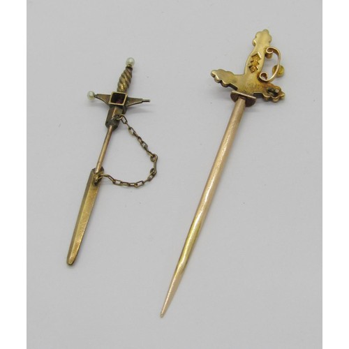 288 - Two sword design jabot pins; a 15ct example set with pearls (a few vacant) and a smaller yellow meta... 