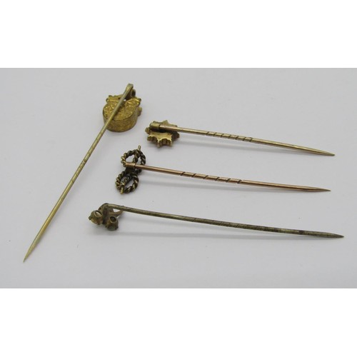 294 - Four antique stick pins comprising a 15ct diamond chip example, a yellow metal rope twist knot pin, ... 