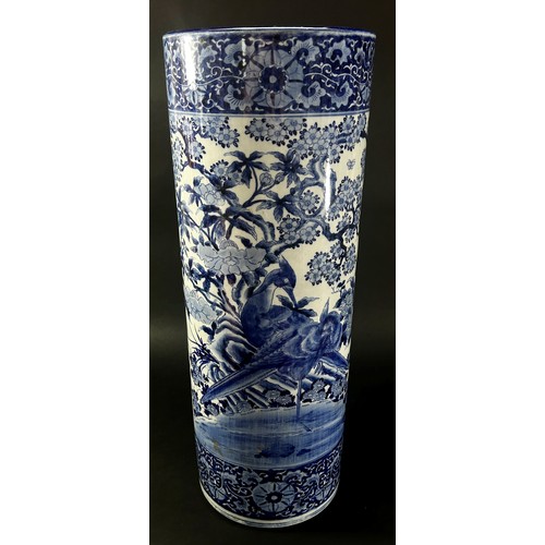 51 - A Chinese blue and white cylindrical stickstand decorated with pheasants, foliage and set within rep... 