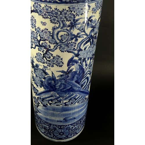 51 - A Chinese blue and white cylindrical stickstand decorated with pheasants, foliage and set within rep... 