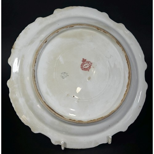 61 - A Limoge porcelain cabinet plate, hand painted with a fish rising at the foot of a waterfall within ... 