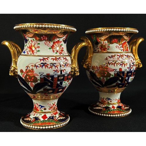 69 - A pair of early 19th century Spode vases with applied loop handles and mask borders, with hand paint... 