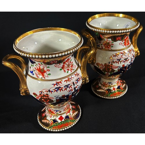 69 - A pair of early 19th century Spode vases with applied loop handles and mask borders, with hand paint... 