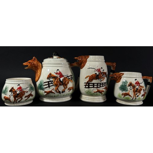 82 - A four piece 'Huntsman' ceramic tea set with fox mask spouts, riding crop handles, etc