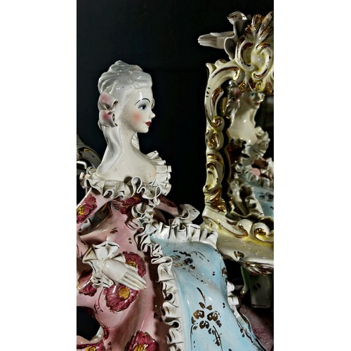 103 - A large Italian pottery group, mid-20th century, courting couple in 18th century dress beside a cons... 