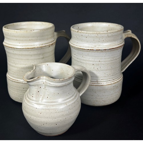 106 - Seven pieces of Winchcombe pottery by Ray Winch including storage jars and covers, two tankards and ... 