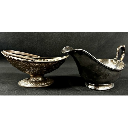 260 - A silver mustard pot and spoon together with a boat shaped dish with a loop handle , a silver pocket... 