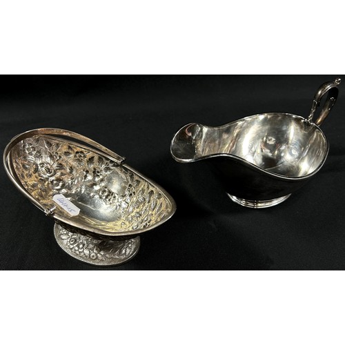 260 - A silver mustard pot and spoon together with a boat shaped dish with a loop handle , a silver pocket... 