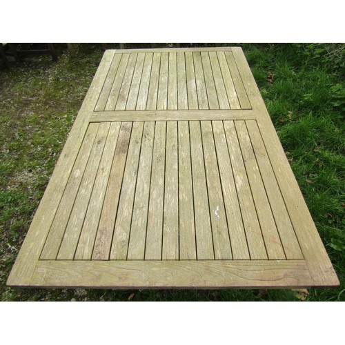 1004 - A Bramblecrest weathered teak folding garden table with rectangular slatted panelled top raised on x... 