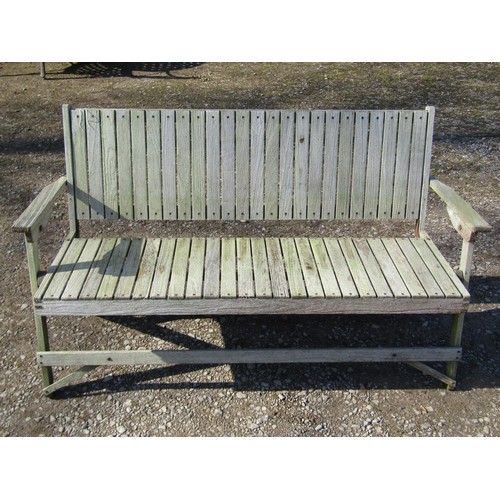 1005 - A weathered (silvered) teak garden suite comprising a folding bench with slatted seat and back 141 c... 