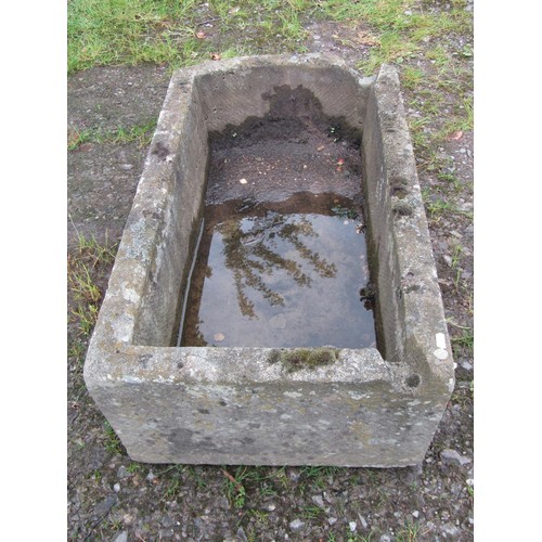 1016 - A weathered carved rectangular natural stone trough with single D shaped end and notched channel, 30... 