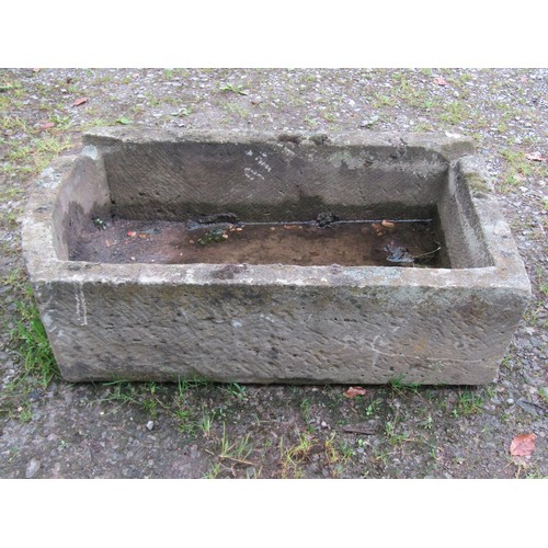 1016 - A weathered carved rectangular natural stone trough with single D shaped end and notched channel, 30... 