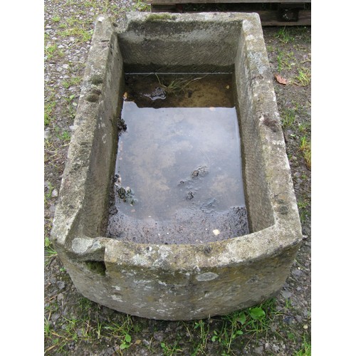 1016 - A weathered carved rectangular natural stone trough with single D shaped end and notched channel, 30... 