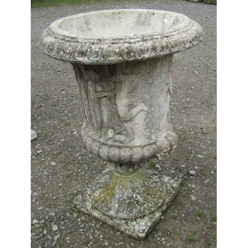 1020 - A weathered cast composition stone campana shaped garden urn with flared egg and dart rim, lobed bod... 