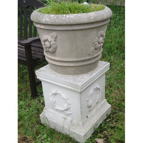 1029 - A weathered cast composition stone garden planter of circular tapered and ribbed form with raised fl... 