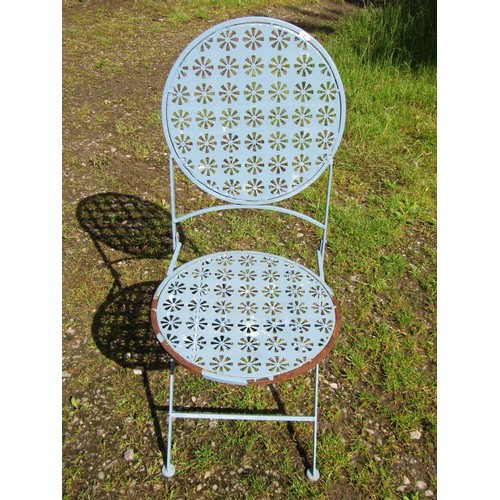 1048 - A weathered light blue painted steel three piece folding garden terrace/bistro set with decorative p... 