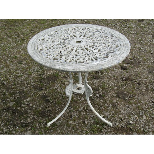 1062 - A weathered cream painted cast aluminium garden terrace table with decorative pierced floral radiati... 