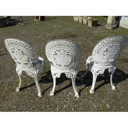 1063 - A set of weathered cream painted cast aluminium garden terrace chairs with decorative pierced geomet... 