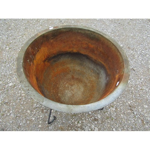 1066 - A vintage weathered cast iron/alloy cauldron/tub with simple flared rim raised on a later associated... 