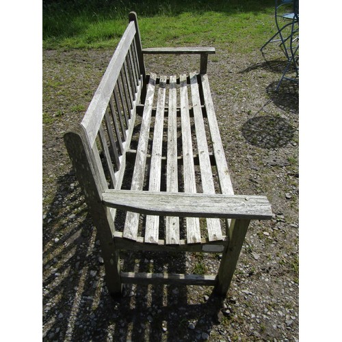 1060 - An R A Lister & Co Ltd weathered teak three seat garden bench with slatted seat and back 158 cm long