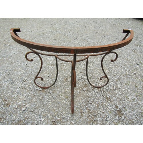 1086 - A weathered heavy gauge iron work demi-lune garden/conservatory table base with open scroll work det... 