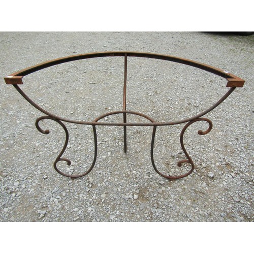 1086 - A weathered heavy gauge iron work demi-lune garden/conservatory table base with open scroll work det... 