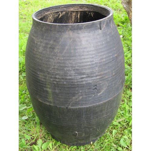 1090 - A weathered coopered oak and steel banded half barrel planter, 39 cm high x 64 cm diameter, together... 