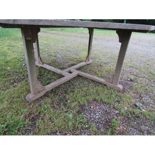 1093 - A large Bramblecrest weathered teak garden table with overhanging octagonal segmented slatted panell... 