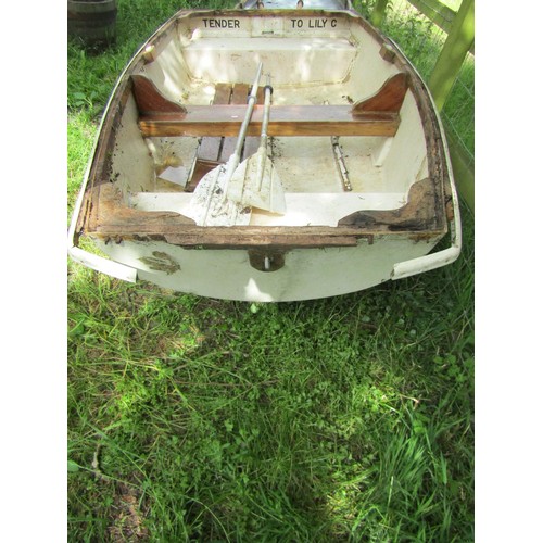 1111 - A small rowing boat with painted fibreglass hull, teak trim and seat, 232 cm x 130 cm approximately ... 