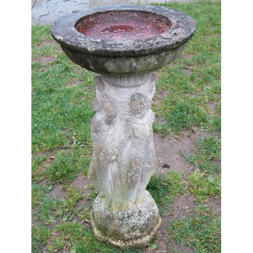 1121 - A weathered cast composition stone two sectional birdbath of circular form raised on a pedestal with... 