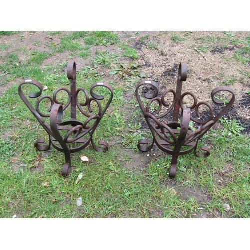 1125 - A pair of weathered heavy gauge iron  work crown shaped  pots stands with open scrollwork detail, 41... 