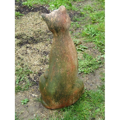 1128 - A weathered terracotta garden ornament in the form of a seated cat, 50 cm high approximately