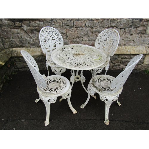 1129 - A cream painted cast aluminium garden terrace table of ciruclar form with decorative pierced top tog... 