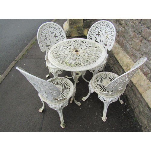 1129 - A cream painted cast aluminium garden terrace table of ciruclar form with decorative pierced top tog... 