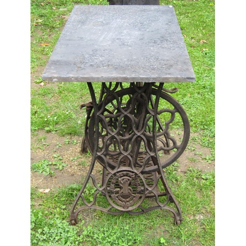 1133 - A Singer cast iron treadle sewing machine base later used as a garden table with associated rectangu... 