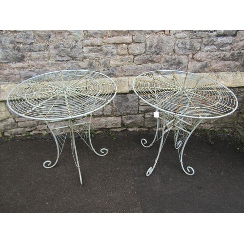 1135 - A pair of weathered good quality contemporary heavy gauge  wirework bistro tables with radiating cir... 