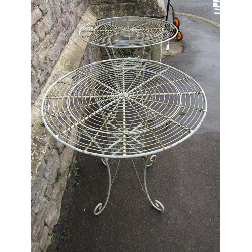 1135 - A pair of weathered good quality contemporary heavy gauge  wirework bistro tables with radiating cir... 