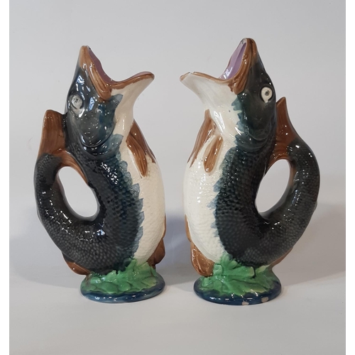 89 - Two majolica leaping fish water jugs and a further collection of Beneagles Scotch Whiskey flasks in ... 