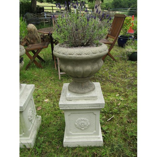 1032 - A pair of weathered cast composition stone garden urns, the circular lobed bowls set on painted squa... 