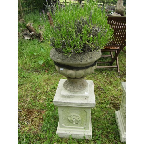 1032 - A pair of weathered cast composition stone garden urns, the circular lobed bowls set on painted squa... 