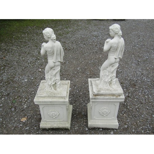 1034 - A matched pair of painted garden ornaments in the form of classical standing male nudes set on squar... 