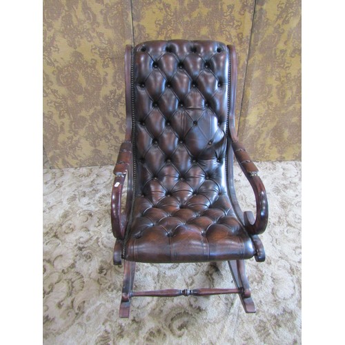 1311 - A Regency style mahogany rocking / library chair, with studded leatherette finish, together with an ... 
